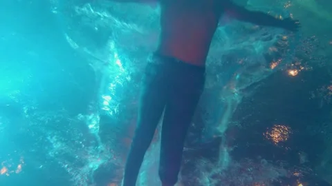 Black guy with dreadlocks falls backwards in an indoor pool 스톡 동영상 148126956