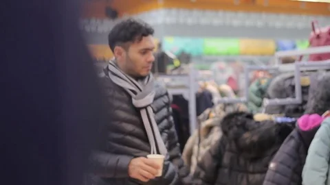 Black guy with Dubai buys in the store winter clothes Stock Footage 82907841