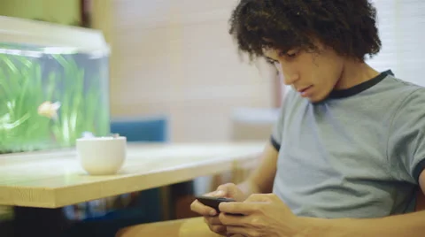 Black guy enjoys smartphone Stock Footage 38822364