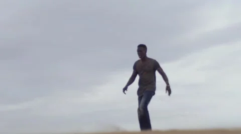 Black guy falls on bended knee at the middle of the desert or morocco 02 Video stock 67559058