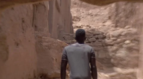 Black guy  going up the stairs of sand at Morocco 02 Stock Footage 67528964