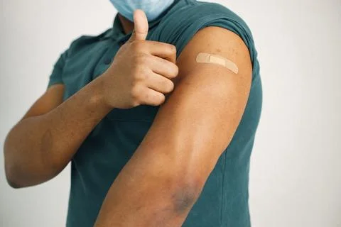 Black guy isolated on white background after covid vaccination Stock Photos