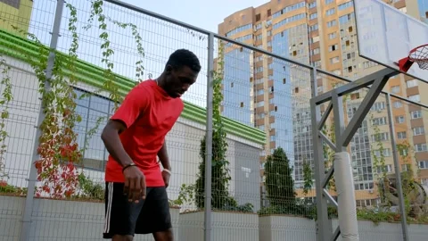 The black guy kicks the ball. A man on a football soccer field Stock Footage 139753588