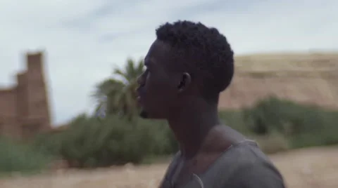 Black guy looking around at the sand houses 11 Video stock 67527571
