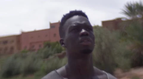 Black guy looking around at the sand houses 20 Stock Footage 67527600
