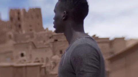 Black guy looking around at the sand houses 15 Stock Footage 67528938