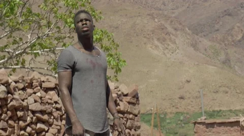 Black guy looking around at the sand houses Stock Footage 67557045