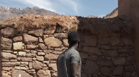 Black guy looking around at the sand houses 03 Stock Footage 67557070