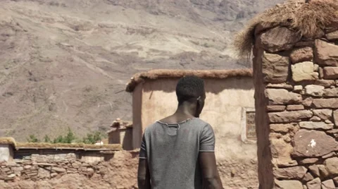 Black guy looking around at the sand houses 09 Stock Footage 67557212