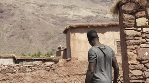 Black guy looking around at the sand houses 06 Stock Footage 67557214