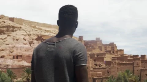 Black guy looking around at the sand houses Stock Footage 67557291