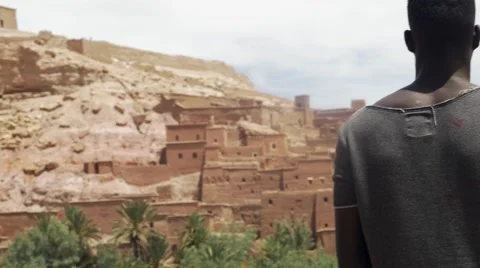 Black guy looking around at the sand houses 08 Video stock 67557301