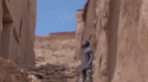 Black guy looking around at the structures of sand at morocco 02 Stock Footage 67528984