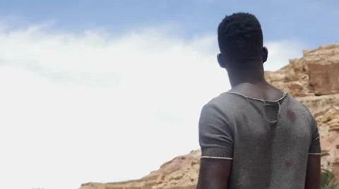 Black guy looking at the sand hill Video stock 67557540