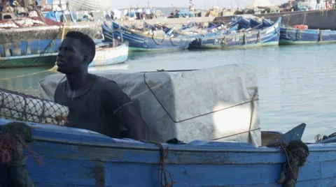 Black guy looks around while riding a boat 04 Stock Footage 67532440