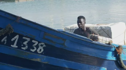 Black guy looks around while riding a boat 07 Stock Footage 67532445