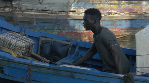 Black guy looks around while riding a boat 09 Video stock 67532775