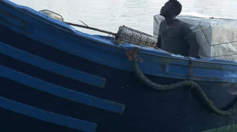 Black guy looks around while riding a boat 08 Stock Footage 67532789