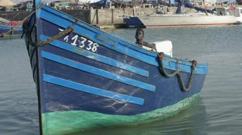Black guy looks around while bringing bringing the dock at the seaside Video stock 67532844