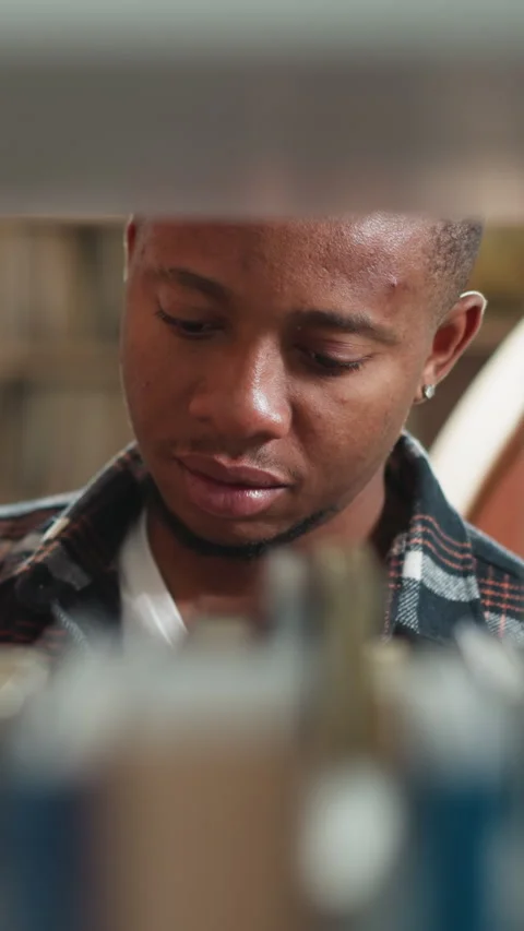 Black guy looks for book on shelf closeup 스톡 동영상 279540586