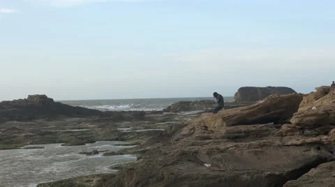 Black guy mourning beside the seashore Stock Footage 67556449