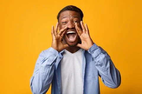 Black Guy Screaming Holding Hands Near Mouth, Studio Shot Stock Photos