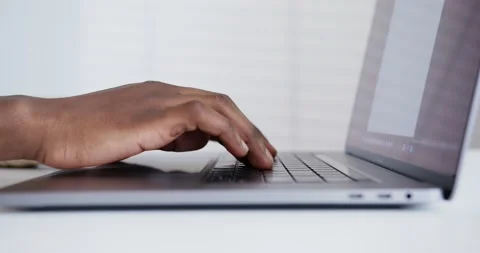 Black guy typing slowly on laptop hands close up Stock Footage 158220941