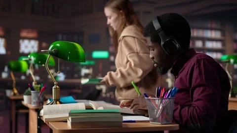 Black guy using study music to help with deep focus for academic success Stock Footage 308725484