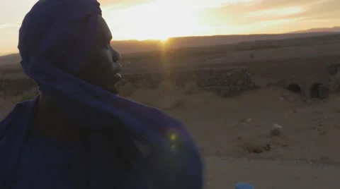 Black guy views at the desert sunset Video stock 67558380