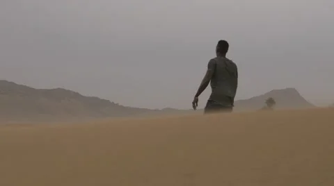 Black guy walking in the middle desert of morocco Видео 67558557