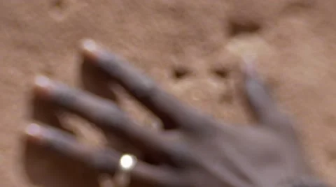 Black guy's hand touching the sand wall 02 Video stock 67528980