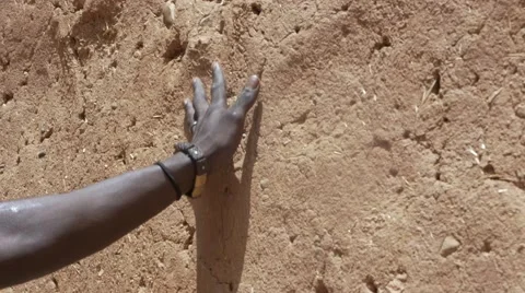 Black guy's hand touching the sand wall Stock Footage 67557880