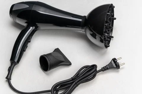 Black hair dryer with diffuser attachment and power cord, showcasing sleek 스톡 사진