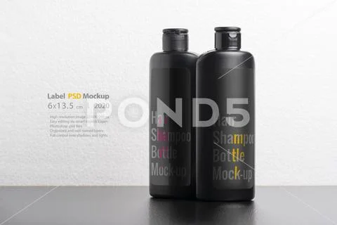 Black hair shampoo bottles in front of  light gray background mock-up series PSD Template