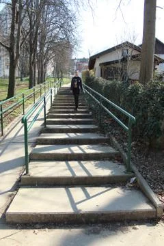 Black haired girl on the stairs in the park Stock Photos