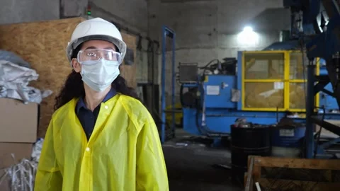 Black-haired inspector walks past conveyor belt with trash Stock Footage 243070425