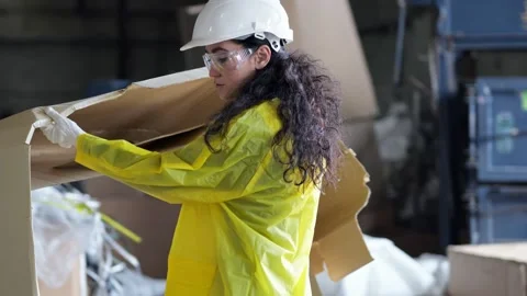 Black-haired supervisor helps sorting waste at factory Stock Footage 243071690