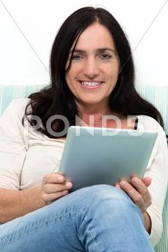 Black haired woman using a table pc Stock Photos