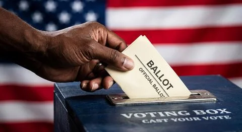 Black hand casting ballot into voting box with American flag Stock-Fotos