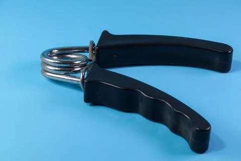 Black hand grip on blue background Stock Photos