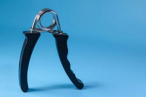 Black hand grip standing position on blue background Stock Photos