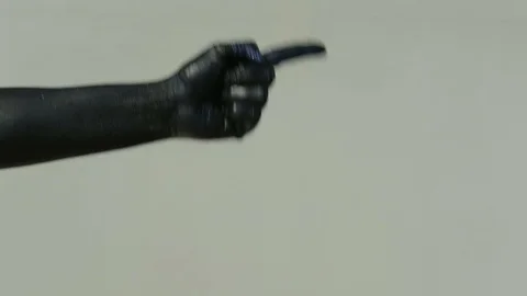 A black hand on a light wall shows a pantomime with an index finger Stock Footage