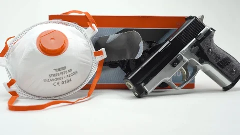 Black Hand Loading A Gun Disposable Gloves Face Mask Stock Footage 126016387