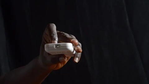 Black hand pressing a  remote control Stock Footage 276594355