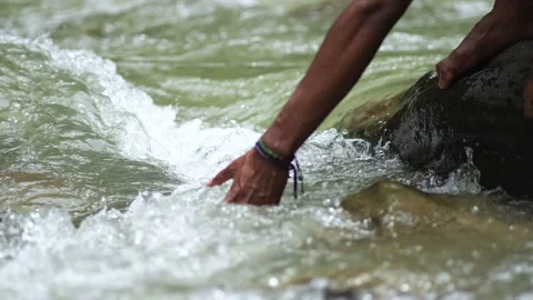 A Black Hand Trying to Grasp The Stream of Water Stock Footage 207355788