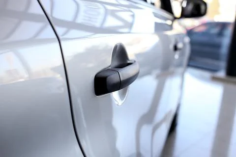 Black handle of a large silver car Stock Photos