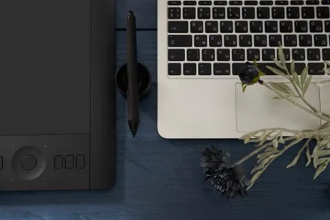 Black handle professional graphics tablet, notebook and flower top Photos