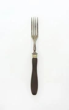 Black handled metal fork on plain background Stock Photos