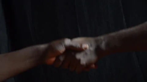 Black hands in a handshake Stock Footage 276594339