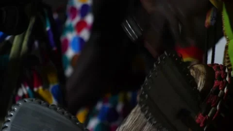 Black hands playing djembe with drum rings from side Stock Footage 208940490